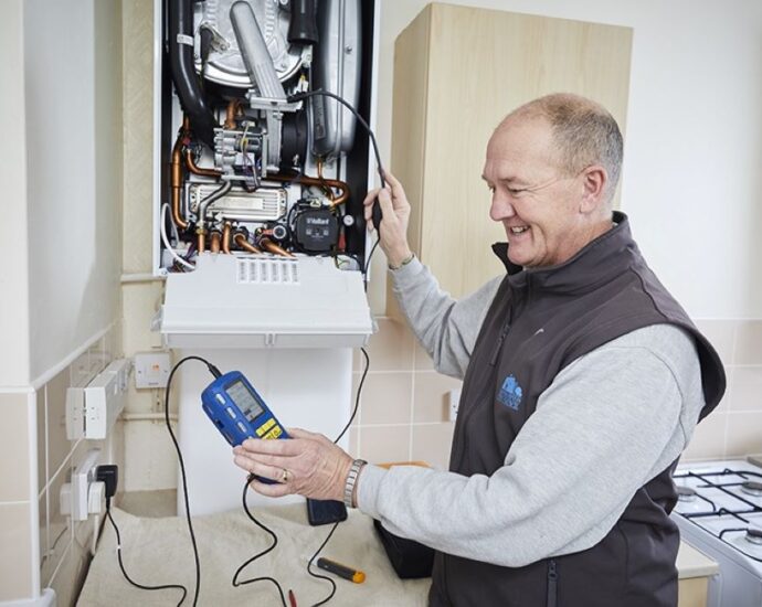 Southampton homeowner inspecting a boiler with a technician, illustrating expert tips for troubleshooting and maintaining a smooth-running heating system