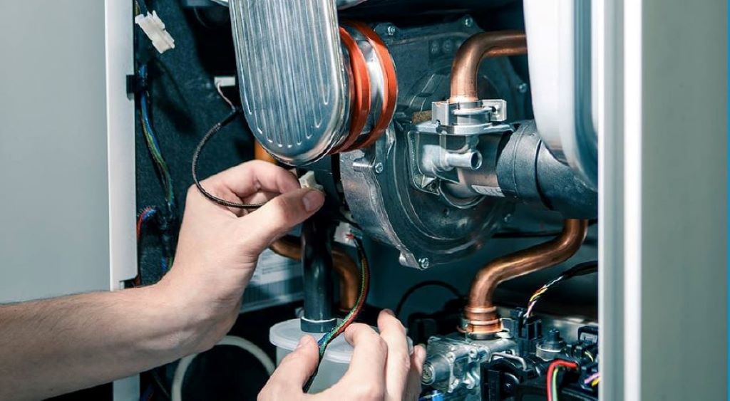 Professional boiler repair technician in Bristol fixing a home heating system to keep families warm and cozy