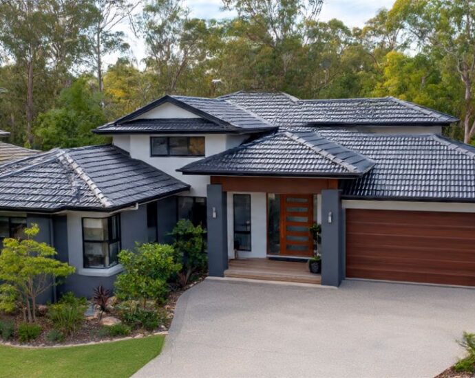 Modern home exterior featuring photocatalytic roofing tiles in charcoal gray with clean self-maintained surface