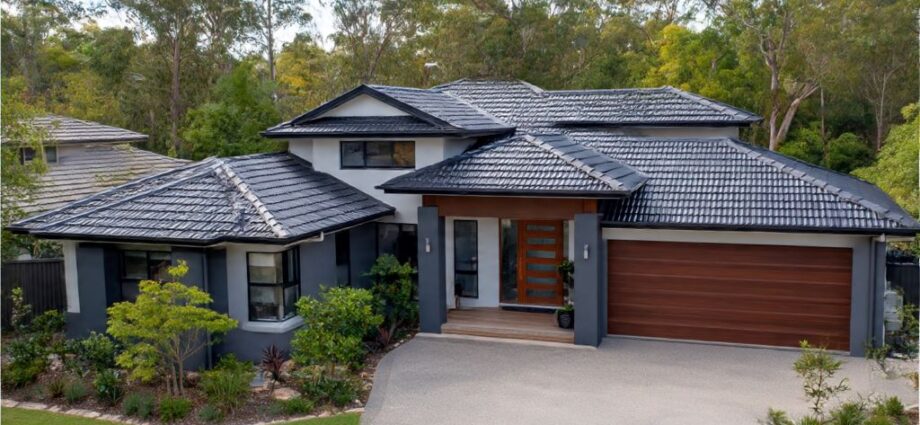 Modern home exterior featuring photocatalytic roofing tiles in charcoal gray with clean self-maintained surface