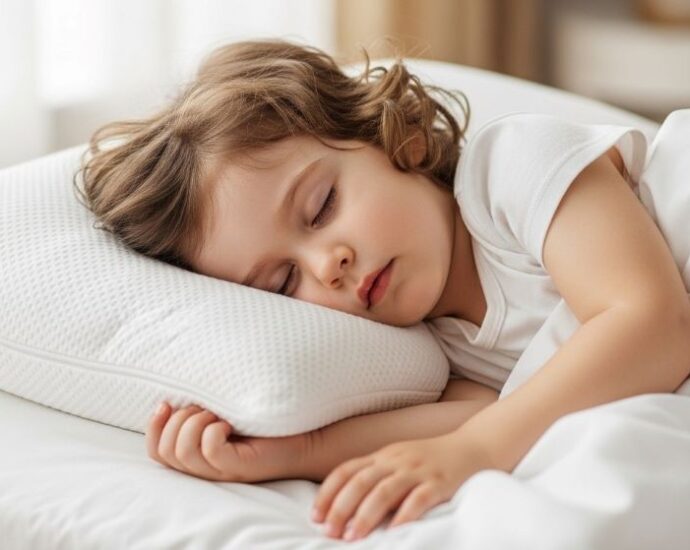 Child sleeping peacefully on hypoallergenic pillow designed to block dust mites and allergens