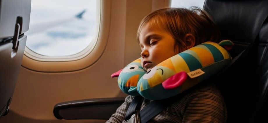 Toddler sleeping comfortably with neck pillow during airplane journey