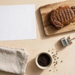 Blank reference sheet with grilled steak thermometer and towel on a counter